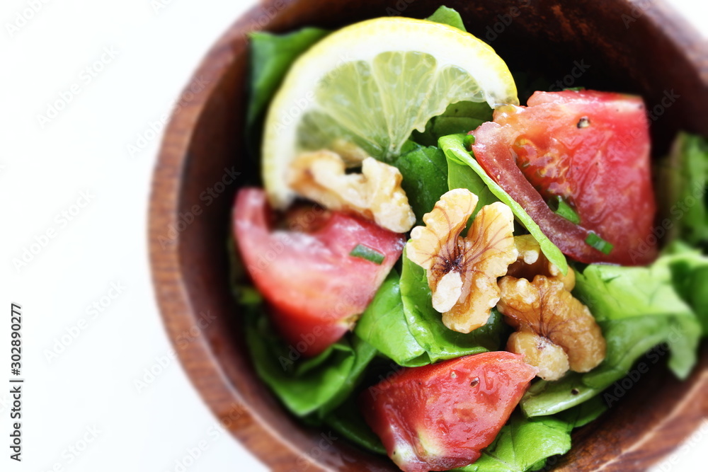 Tomato and walnut salad on white background with copy space Tomato and walnut salad on white background with copy space