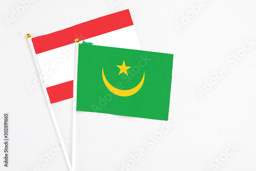 Mauritania and Lebanon stick flags on white background. High quality fabric, miniature national flag. Peaceful global concept.White floor for copy space.