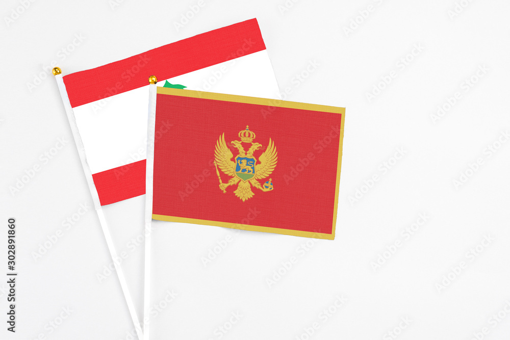 Montenegro and Lebanon stick flags on white background. High quality fabric, miniature national flag. Peaceful global concept.White floor for copy space.