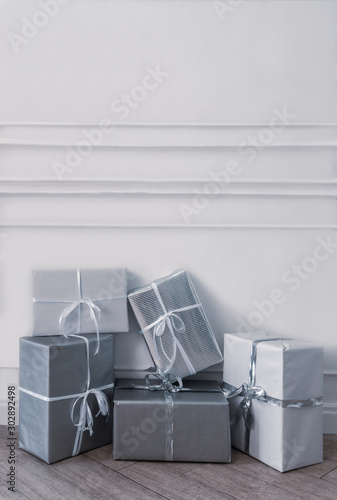 Christmas gift boxes in front of white wall photo