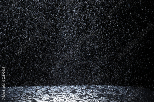 Dark background shot of rain falling