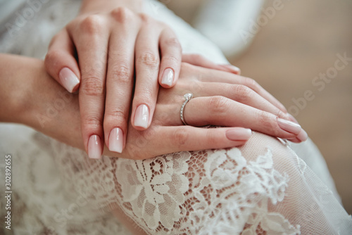 Close up of woman hands with pastel wedding manicure, copy space
