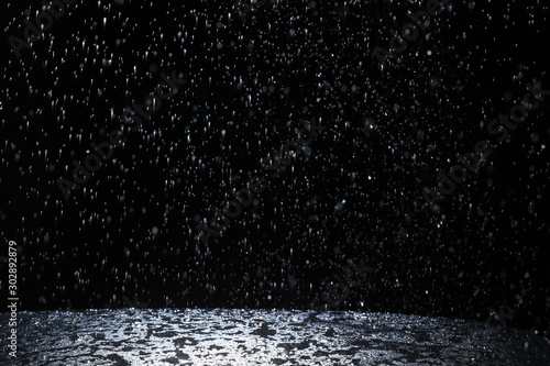 Dark background shot of rain falling