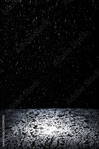 Dark background shot of rain falling