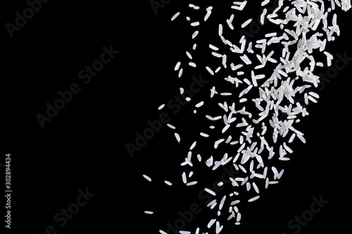 Heap of raw rice on dark background