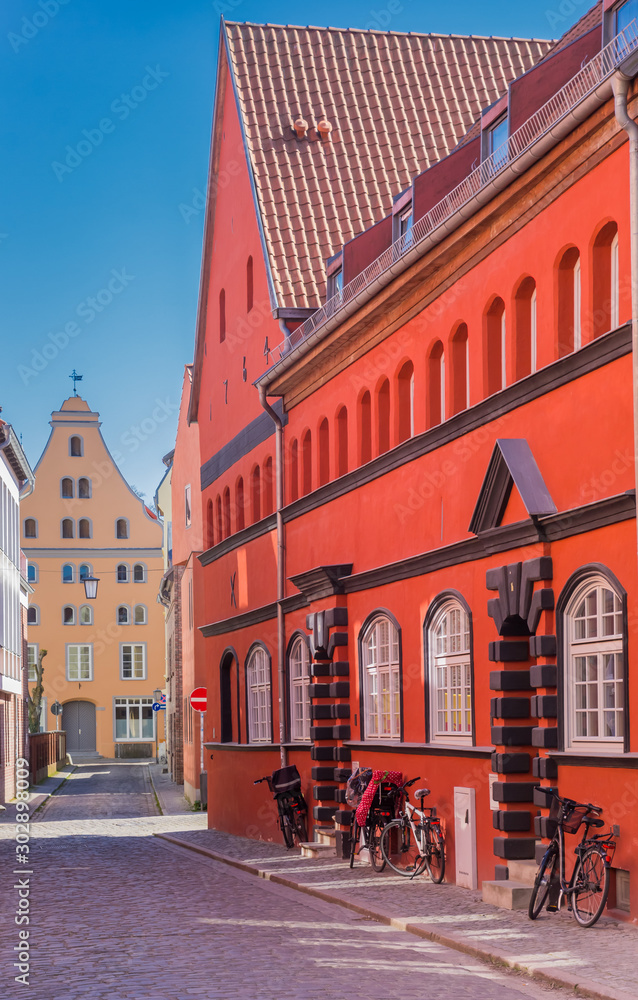 Historic red house at a cobblestoned street in Stralsund, Germany