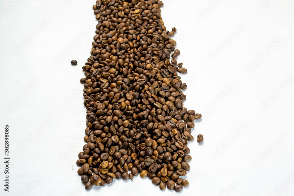 coffee beans sprinkled on a table isolated on a white background coffee beans sprinkled on a table isolated on a white background