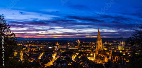 Germany, XXL panorama of freiburg im breisgau skyline from above in magical afterglow sunset light by night