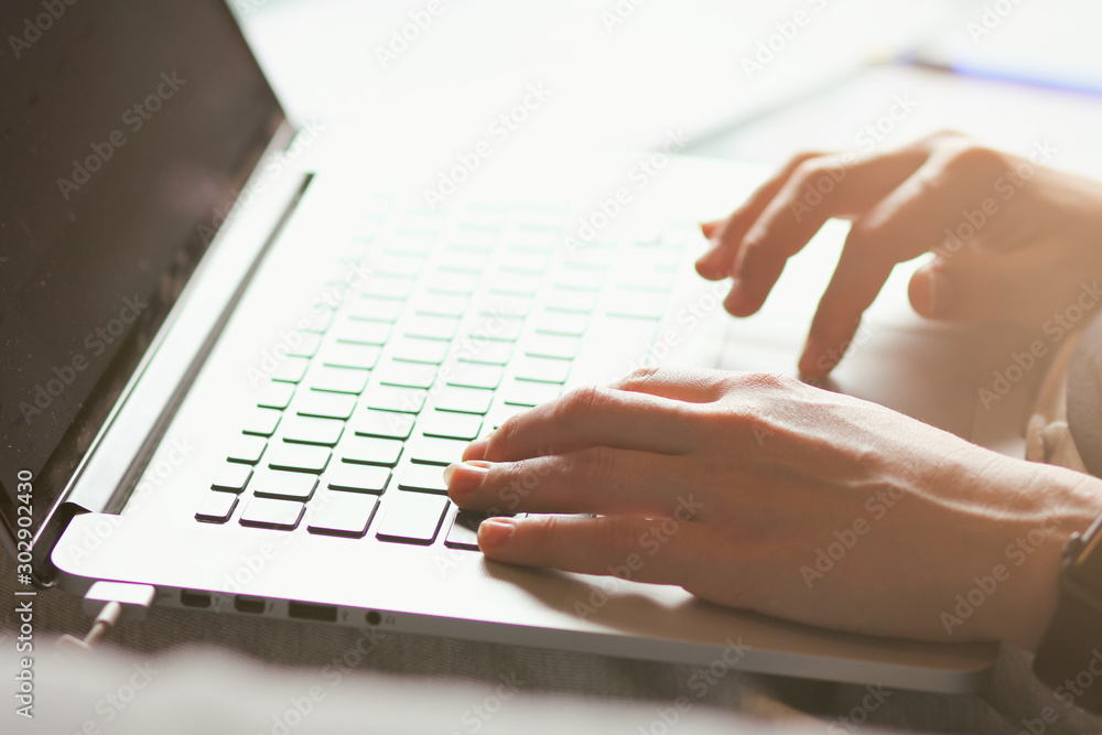 Young woman typing on a laptop keyboard. Close-up details. Girl's hands. Working online. Freelance concept. Shop on the couch. Online shopping. Young woman typing on a laptop keyboard. Close-up details. Girl's hands. Working online. Freelance concept. Shop on the couch. Online shopping.
