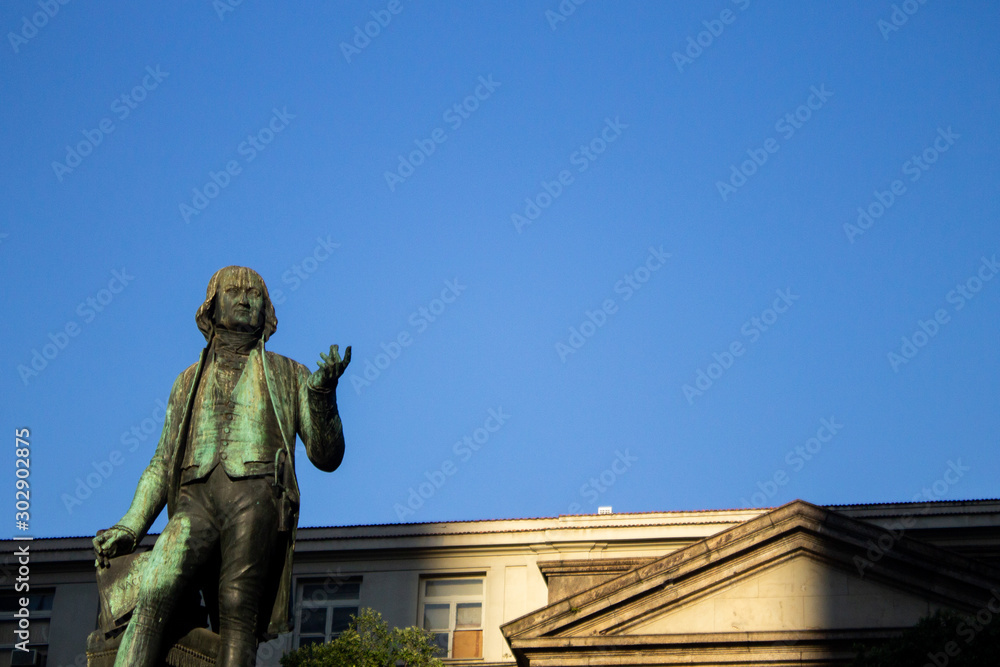 José Bonifácio statue in the San Francisco de Paula square just in front of the Institute of Philosophy and Social Sciences of the Federal University of Rio de Janeiro under a blue sky