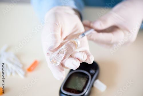 Docto fills a syringe for insulin injections. Diabetes. The shortacting insulin. Insulin injection