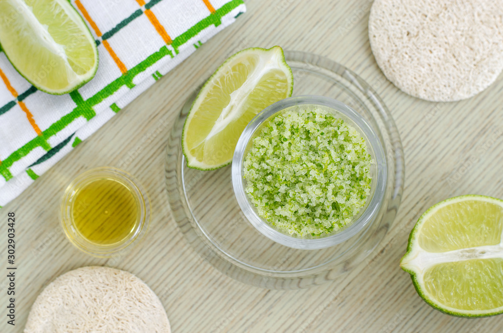 Homemade lime scrub with lime zest and juice, sea salt and olive oil. DIY beauty treatments and spa recipe. Top view, copy space. Homemade lime scrub with lime zest and juice, sea salt and olive oil. DIY beauty treatments and spa recipe. Top view, copy space.