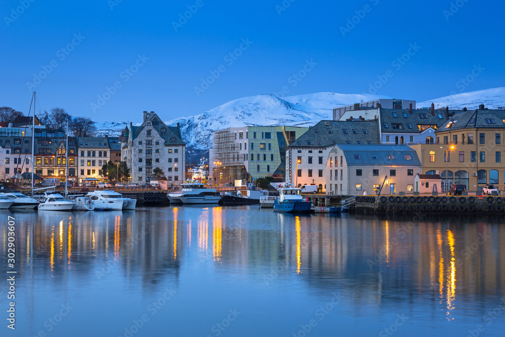 Architecture of Alesund city reflected in the water, Norway