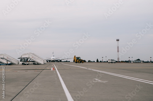13.07.2018 Tbilisi, Georgia: a photo of the bottom of the marked asphalt at the airport with planes and airport shuttle serving