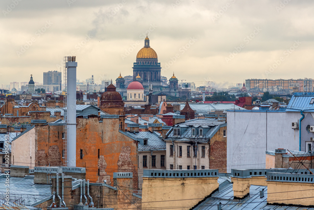 Beautiful top view of the historical center of St. Petersburg, roofs of buildings, chimneys and the golden dome of St. Isaac's Cathedral. Saint-Petersburg, Russia.