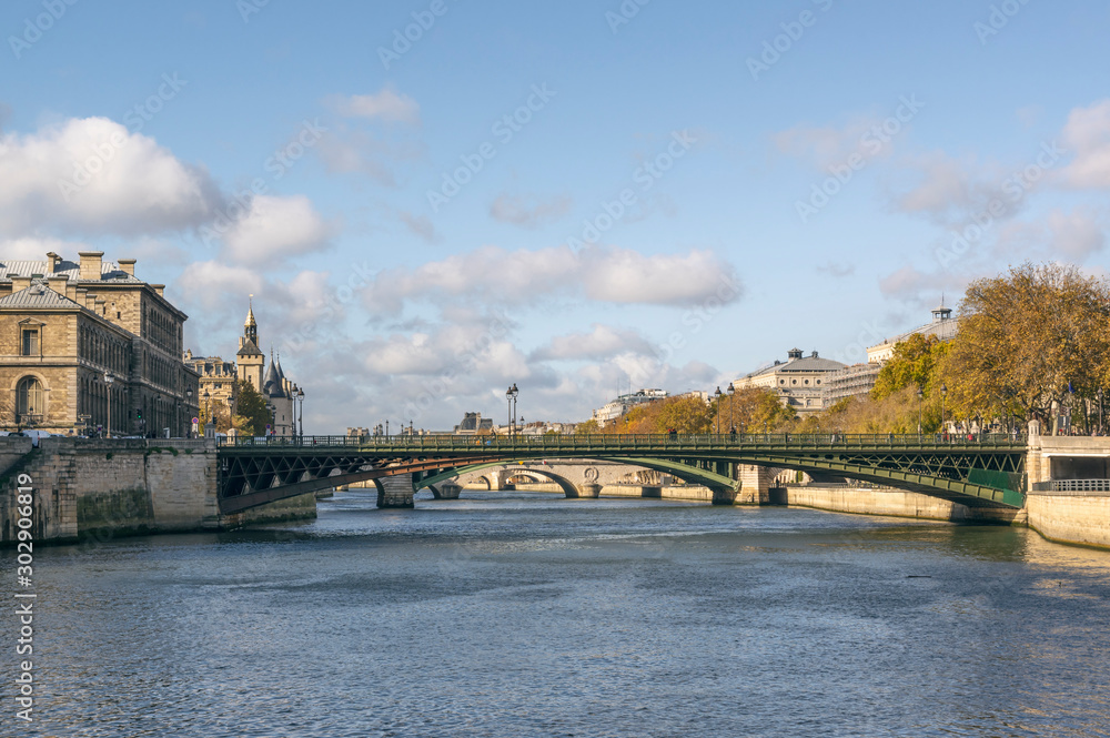 Fototapeta premium Seine River seen from the boat. Bridges connecting the island Cite from northern bank. Pont Notre-Dame first, than Pont au Change. Taken on beautiful autumn day