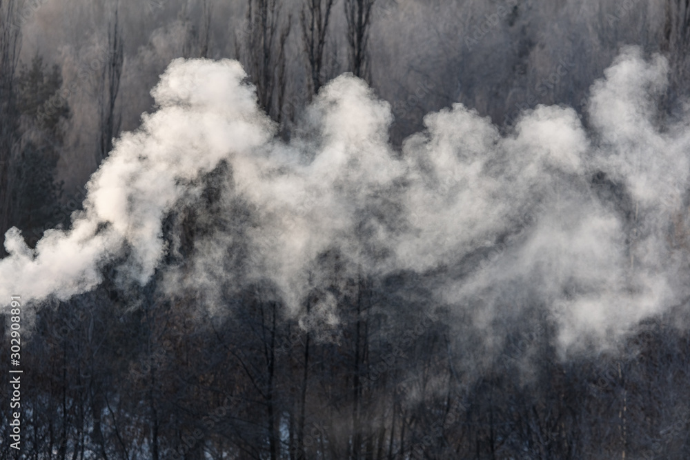 Smoke from the chimney of a house at dawn of the sun Smoke from the chimney of a house at dawn of the sun