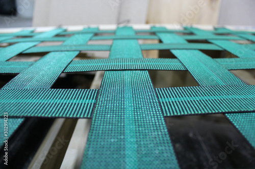 Sofa frame in the furniture industry. Rubber band on the frame of the frame. The process of assembling the sofa.