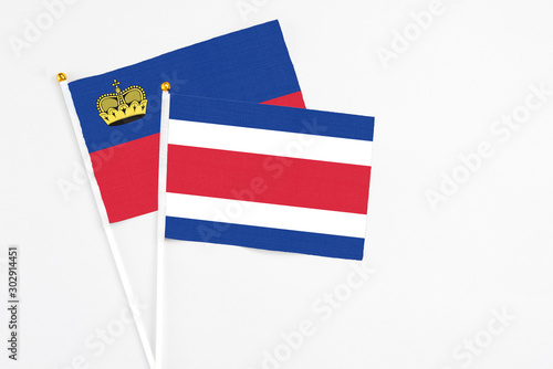 Free Download Costa Rica and Liechtenstein stick flags on white background. High quality fabric, miniature national flag. Peaceful global concept.White floor for copy space. - GFXLoad