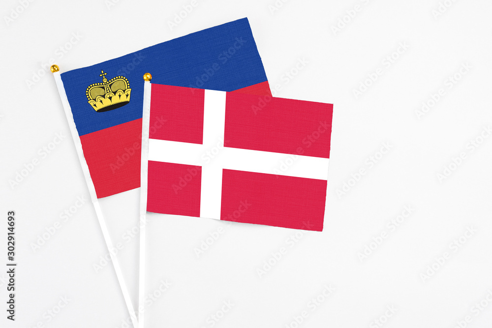 Denmark and Liechtenstein stick flags on white background. High quality fabric, miniature national flag. Peaceful global concept.White floor for copy space.