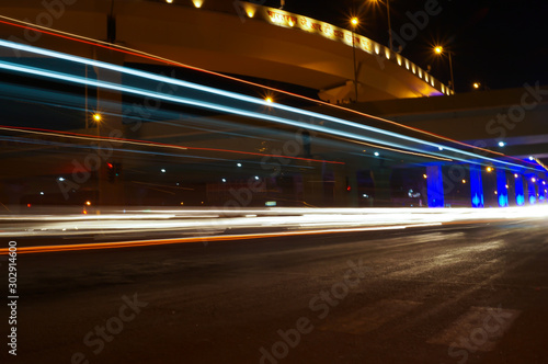 Vector image of colorful light trails with motion blur effect, long time exposure. © Laxmikant