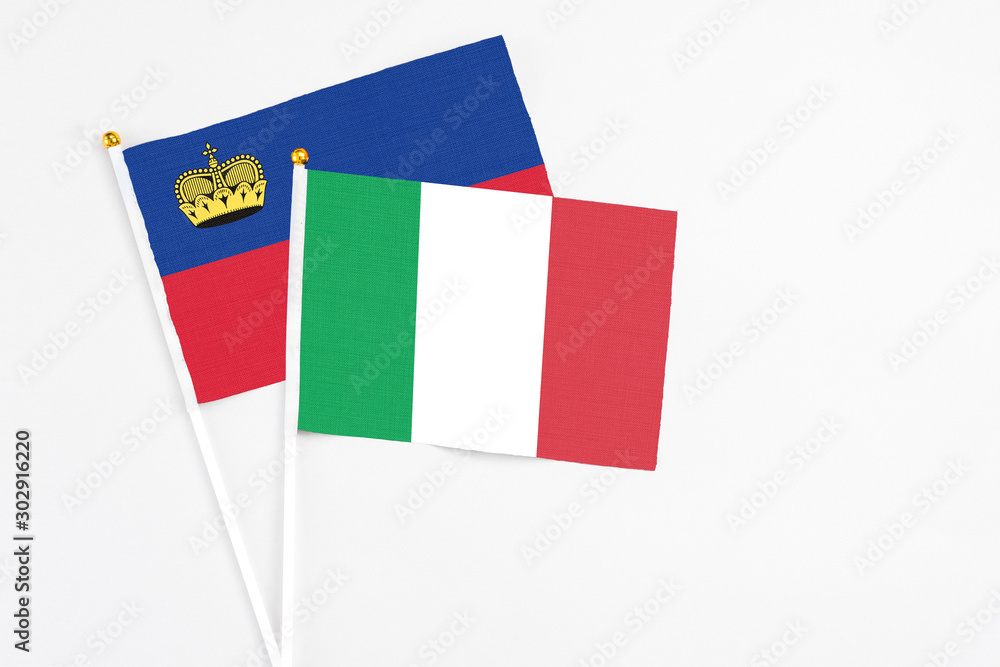 Italy and Liechtenstein stick flags on white background. High quality fabric, miniature national flag. Peaceful global concept.White floor for copy space.