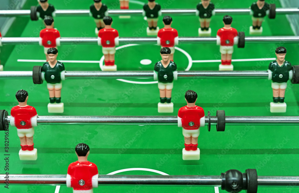 Table football with red and green players on the field. Table football with red and green players on the field.