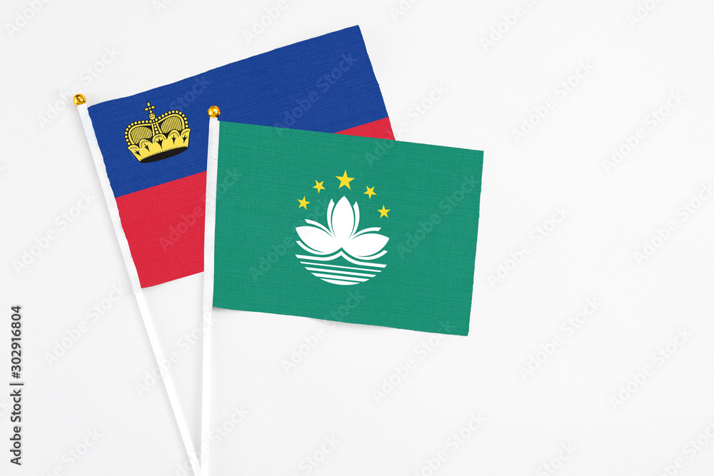 Macao and Liechtenstein stick flags on white background. High quality fabric, miniature national flag. Peaceful global concept.White floor for copy space. Macao and Liechtenstein stick flags on white background. High quality fabric, miniature national flag. Peaceful global concept.White floor for copy space.
