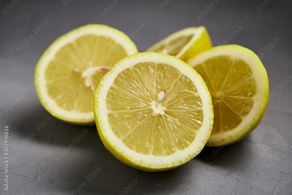 Cut lemon on a grey background. Healthy fruits. Cut lemon on a grey background. Healthy fruits.