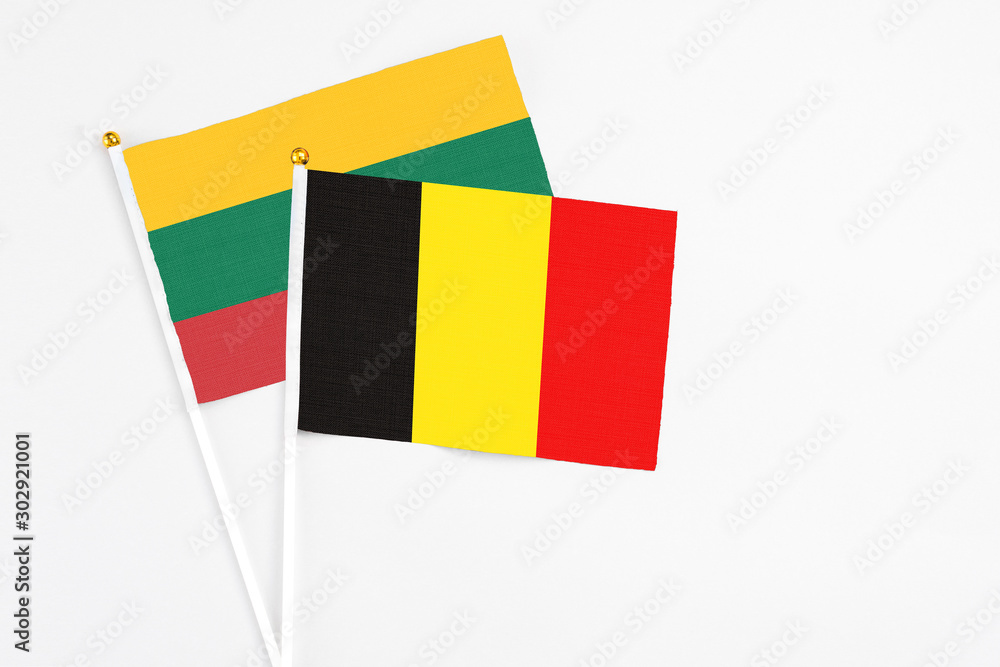 Fototapeta premium Belgium and Lithuania stick flags on white background. High quality fabric, miniature national flag. Peaceful global concept.White floor for copy space.