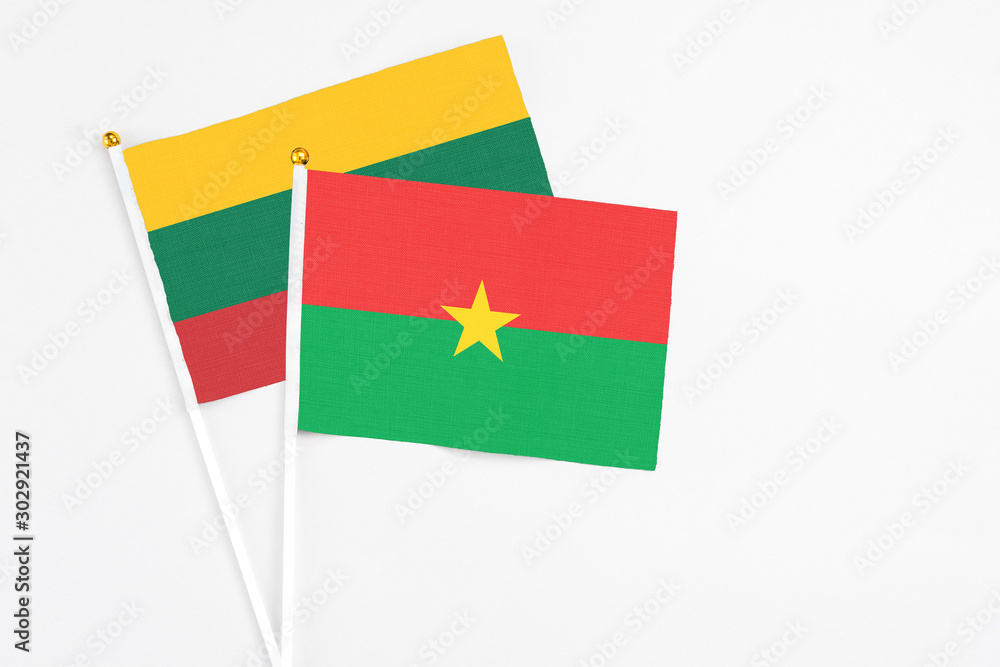Burkina Faso and Lithuania stick flags on white background. High quality fabric, miniature national flag. Peaceful global concept.White floor for copy space. Burkina Faso and Lithuania stick flags on white background. High quality fabric, miniature national flag. Peaceful global concept.White floor for copy space.