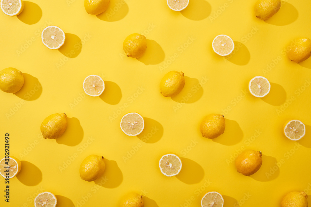 top view of ripe cut and whole lemons on yellow background top view of ripe cut and whole lemons on yellow background