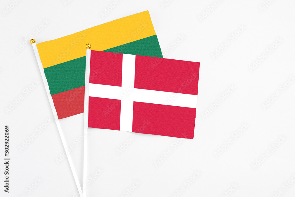 Denmark and Lithuania stick flags on white background. High quality fabric, miniature national flag. Peaceful global concept.White floor for copy space.