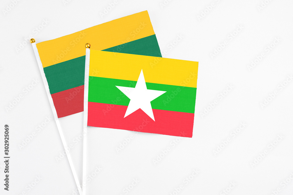 Myanmar and Lithuania stick flags on white background. High quality fabric, miniature national flag. Peaceful global concept.White floor for copy space.