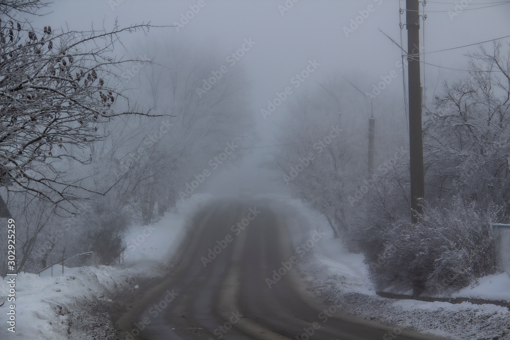 Fototapeta premium A Winter road to the fog