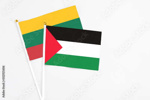 Free Download Palestine and Lithuania stick flags on white background. High quality fabric, miniature national flag. Peaceful global concept.White floor for copy space. - GFXLoad