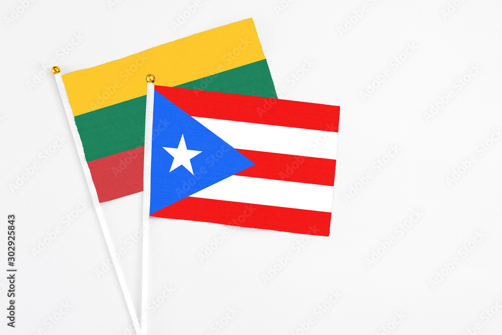Puerto Rico and Lithuania stick flags on white background. High quality fabric, miniature national flag. Peaceful global concept.White floor for copy space.