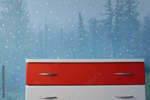 blue star forestry background and white nightstand photo