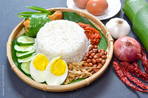 Nasi Lemak is commonly found food in Malaysia, Brunei and Singapore. It is an unofficial national food in Malaysia. Selective focus. photo