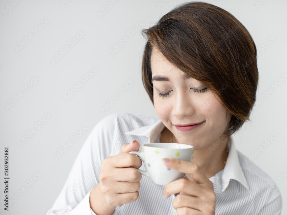 Businesswoman drinking coffee and looking out window. Businesswoman drinking coffee and looking out window.
