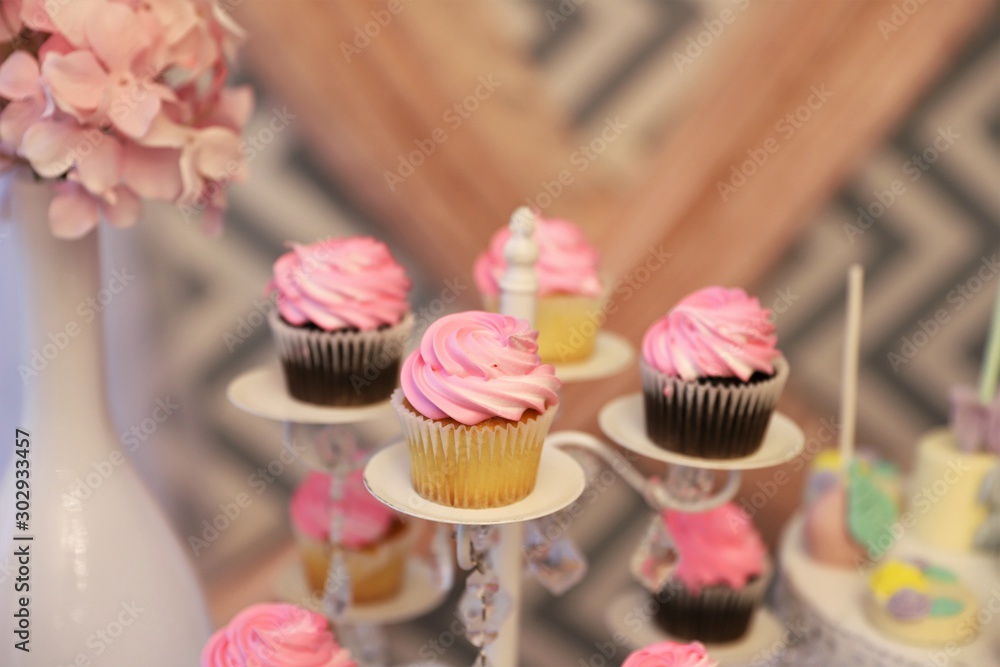 Close up of pink cupcakes on a stand for baby shower