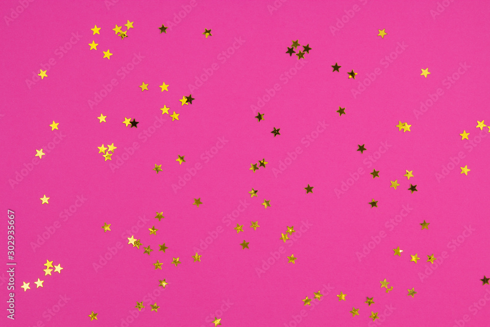 Golden stars confetti on bright pink background. Invitation, congratulation concept. Top view, flat lay, copy space