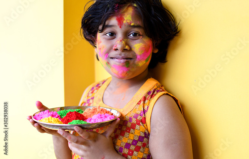 Indian little girl celebrates holi festival 