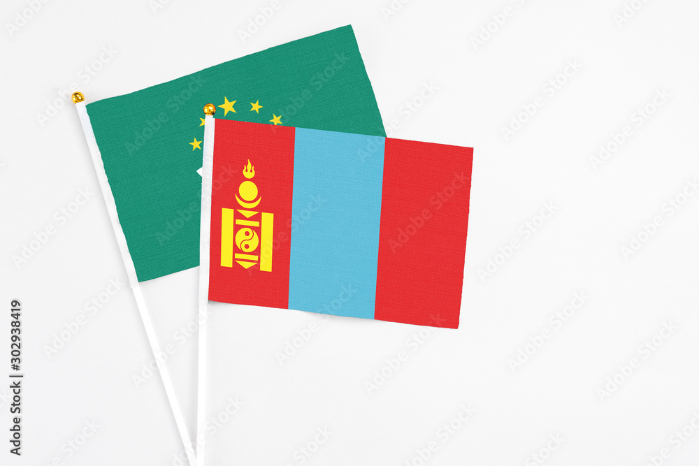 Fototapeta premium Mongolia and Macao stick flags on white background. High quality fabric, miniature national flag. Peaceful global concept.White floor for copy space.