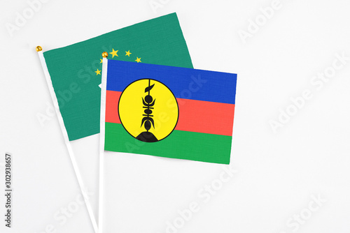 Free Download New Caledonia and Macao stick flags on white background. High quality fabric, miniature national flag. Peaceful global concept.White floor for copy space. - GFXLoad