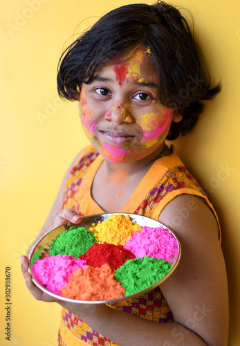 Indian little girl celebrates holi festival 