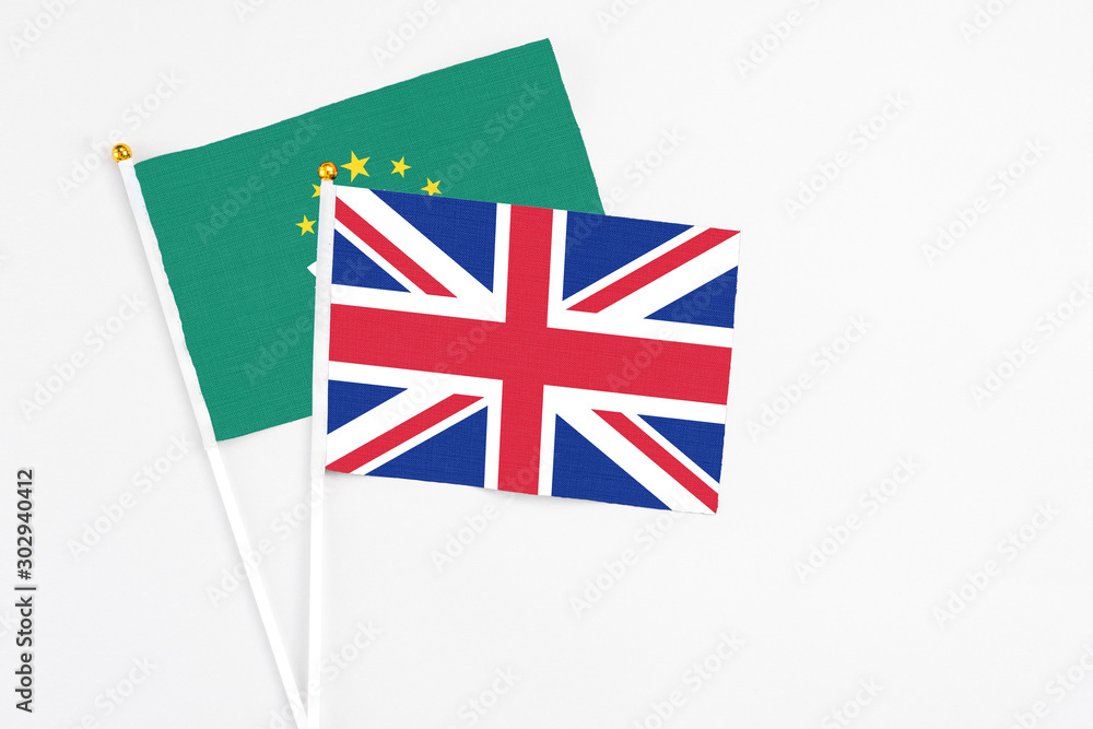 United Kingdom and Macao stick flags on white background. High quality fabric, miniature national flag. Peaceful global concept.White floor for copy space. United Kingdom and Macao stick flags on white background. High quality fabric, miniature national flag. Peaceful global concept.White floor for copy space.