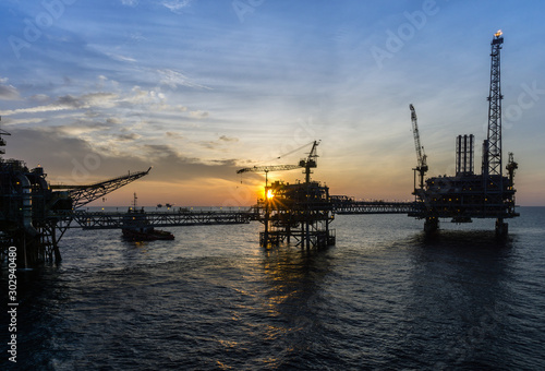 Silhouette of oil production platform at oil field
