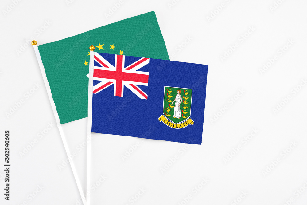 Fototapeta premium British Virgin Islands and Macao stick flags on white background. High quality fabric, miniature national flag. Peaceful global concept.White floor for copy space.
