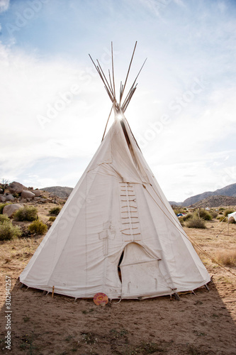 Traditional ceremonial white native american teepee in the desert. 